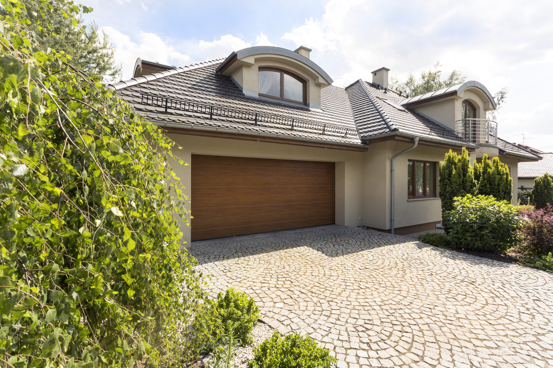 Well-maintained suburban home with paved driveway and double garage