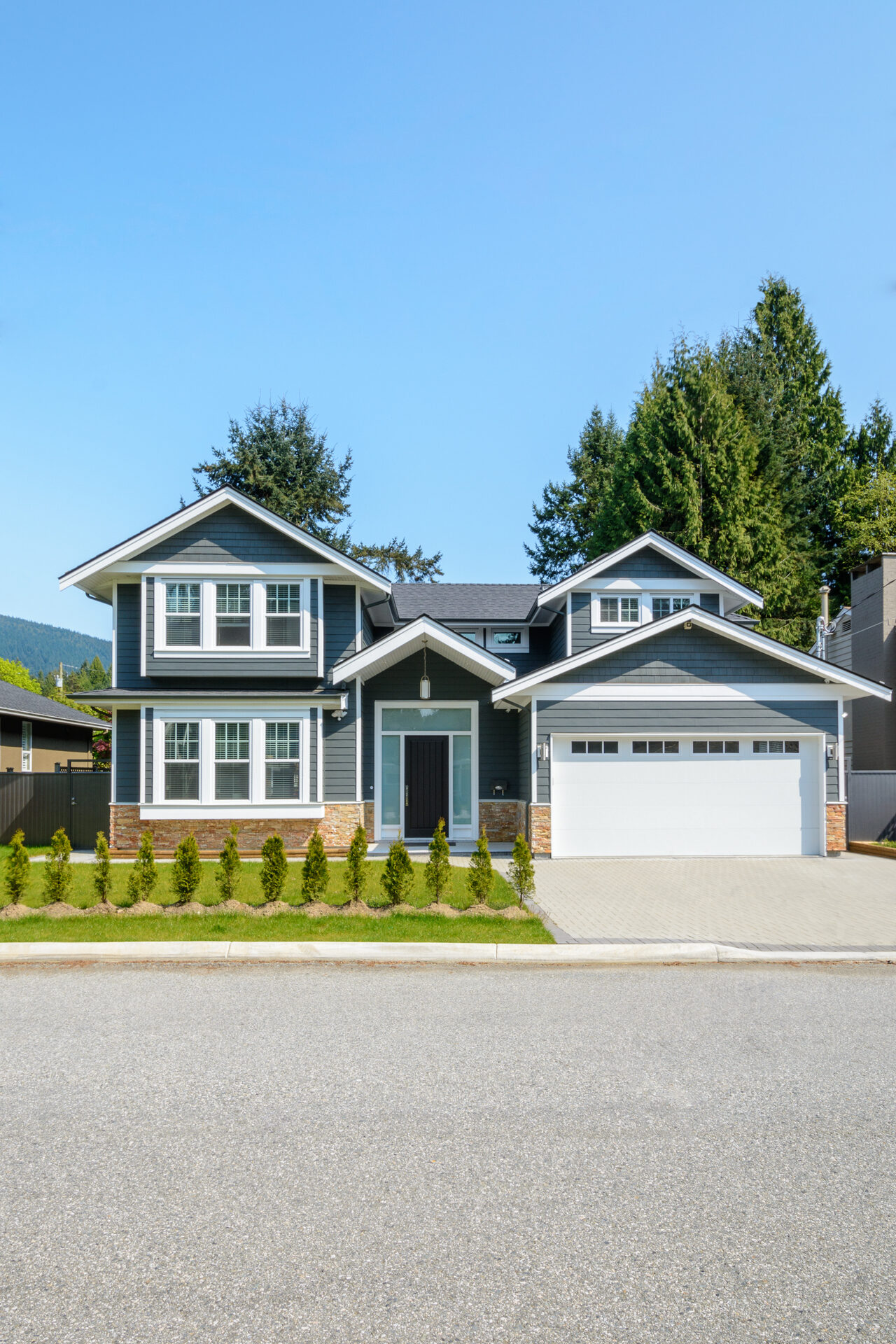 Well-maintained suburban home with manicured lawn and double garage